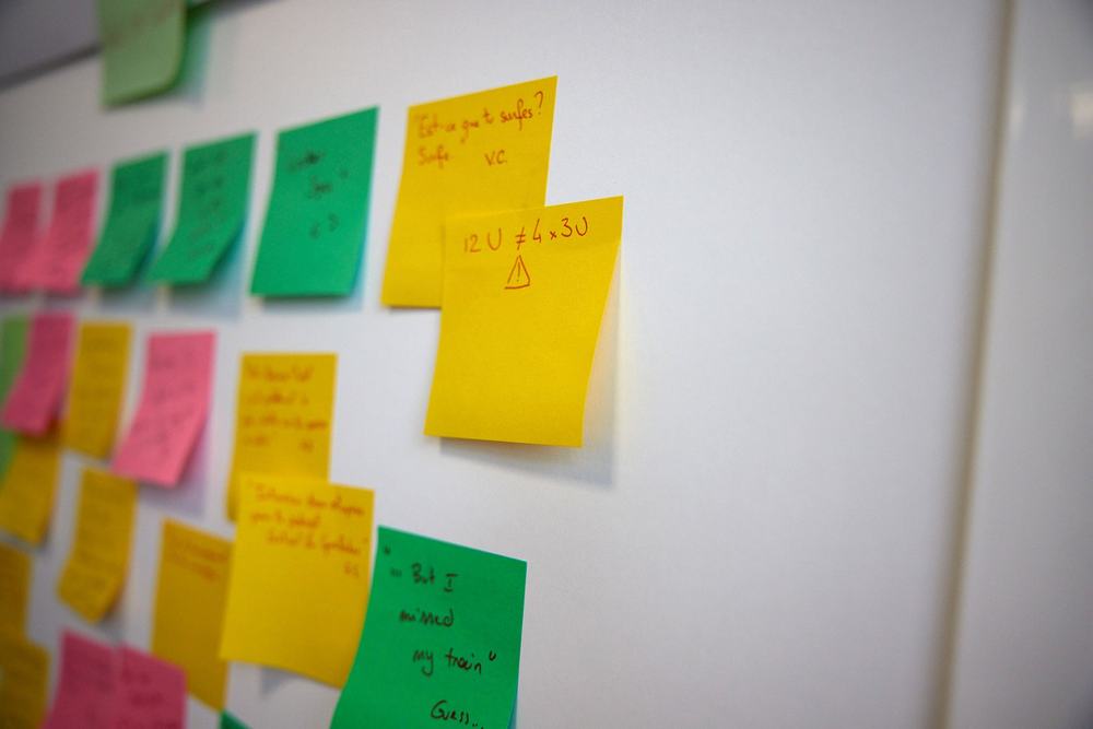 Sticky notes with customer feedback on a whiteboard